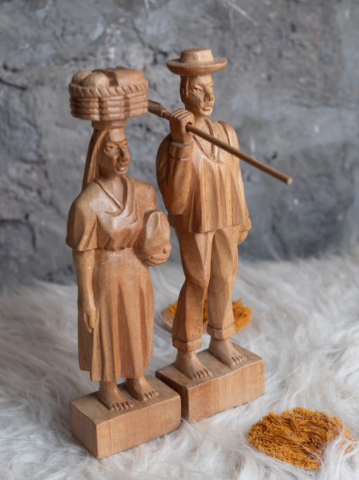 Pareja de figuras indígenas talladas en madera